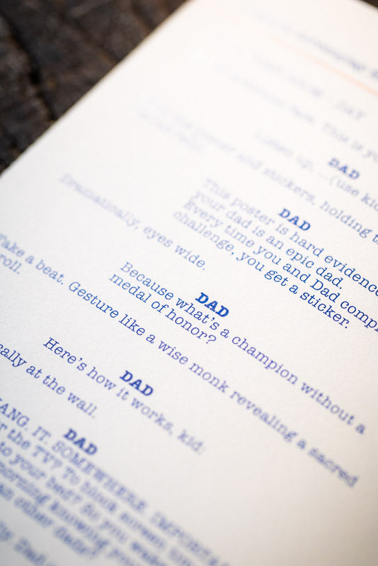 Close-up of the Best Dad Book showing a screenplay-style page
